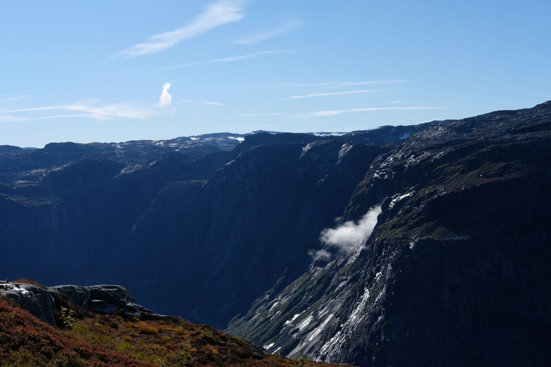 Cliff cradling small cloud.