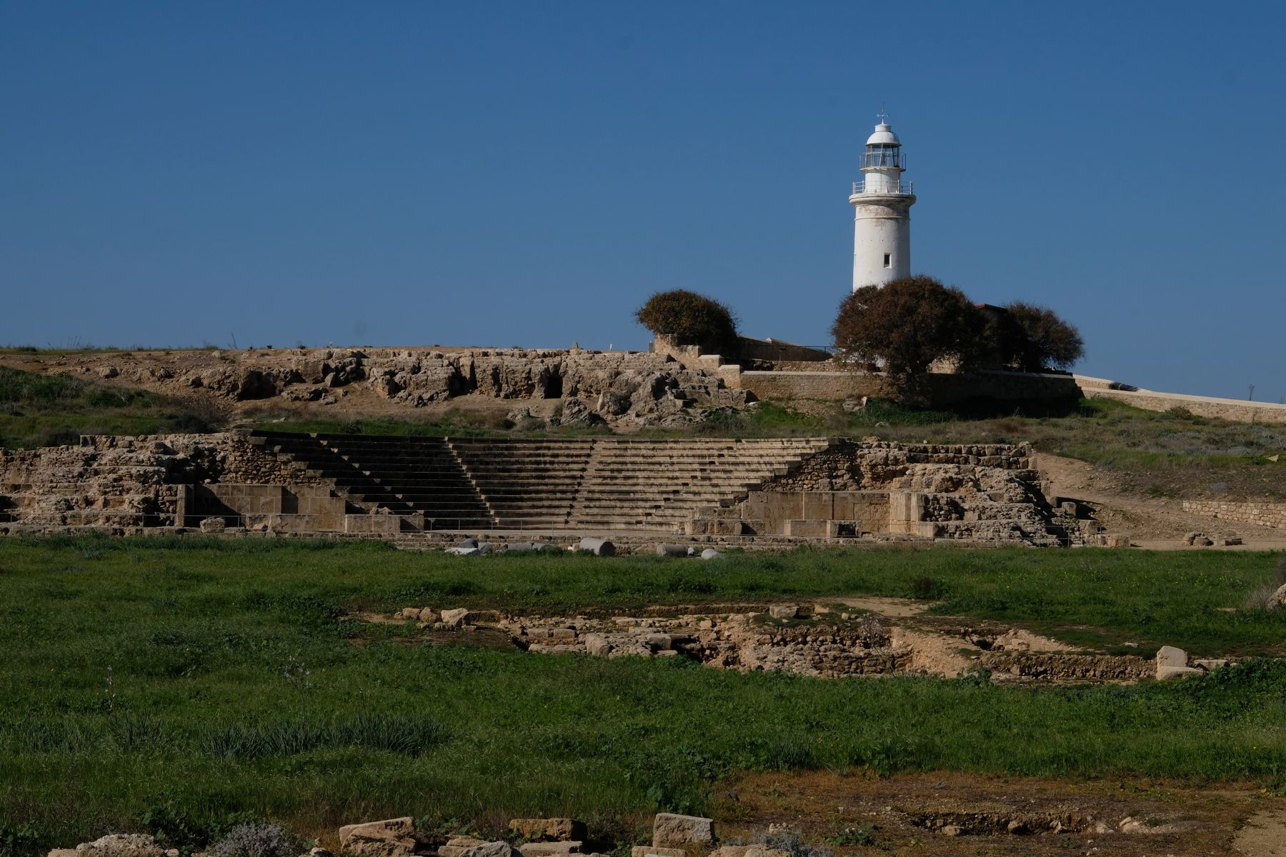 Roman theatre with lighthouse in background in Kato Paphos