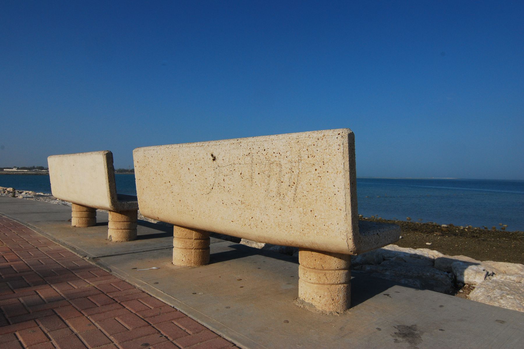 Empty benches by the beach