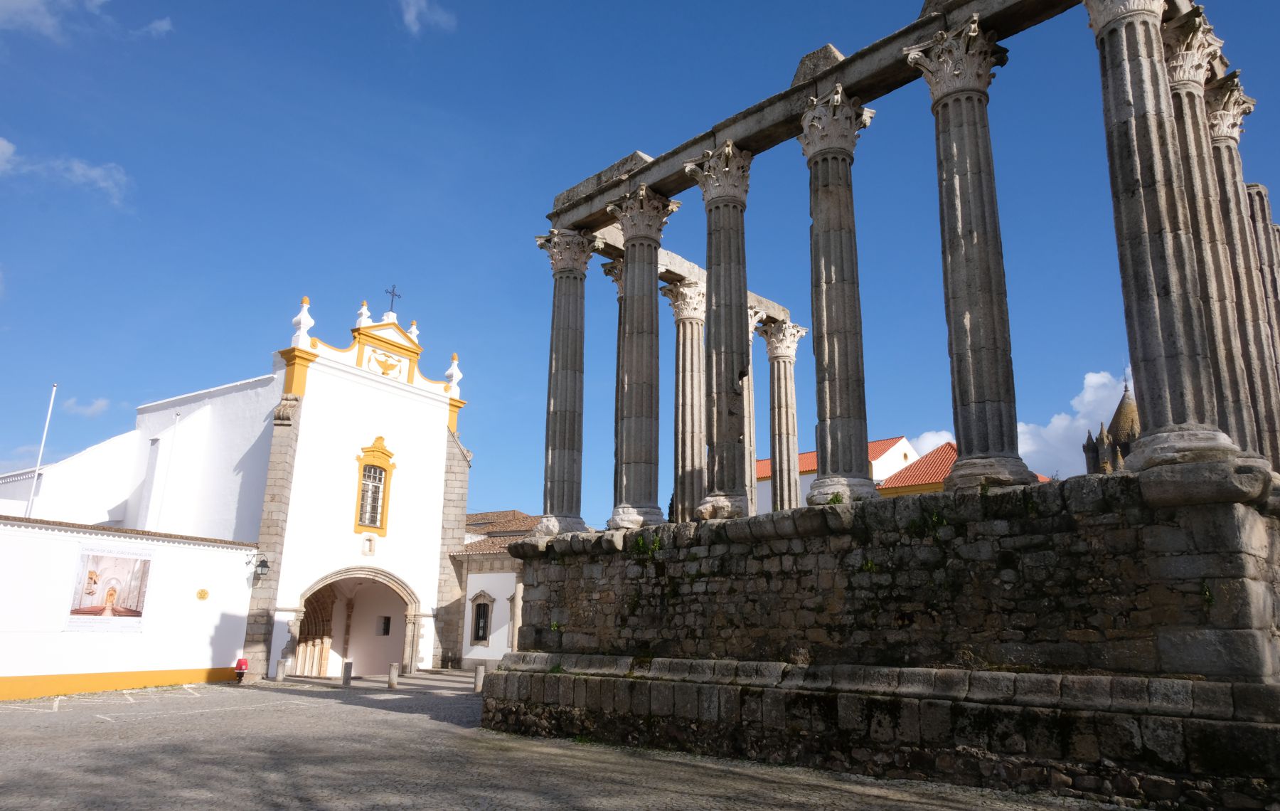 Roman ruins face off Medieval church in Evora.